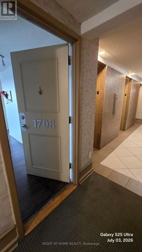 Toronto (Flemingdon Park) condo for rent - A hallway with a door numbered 1708 and a sign that says "Galaxy S25 Ultra".
