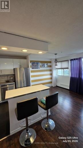 Toronto (Flemingdon Park) condo for rent - A kitchen with a bar stool and a counter.