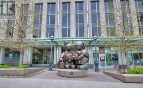 Toronto (Waterfront Communities) condo for rent - A large building with a sculpture in front of it.