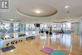 Toronto (Waterfront Communities) condo for rent - A gym with wooden floors and mirrors on the wall.
