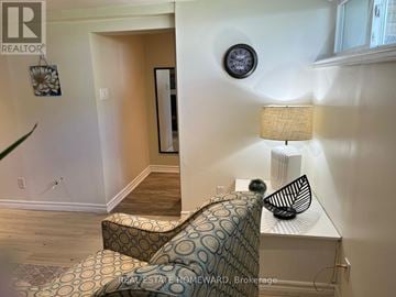Toronto (Woburn) apartment for rent - A living room with a couch and a lamp.