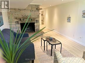 Toronto (Woburn) apartment for rent - A living room with a stone fireplace and a glass table.