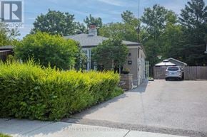 Toronto (Woburn) apartment for rent - A real estate photo of a home with a driveway and a car parked in front.