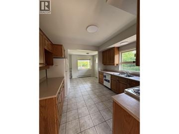 Vancouver apartment for rent - A kitchen with wooden cabinets and a tiled floor.