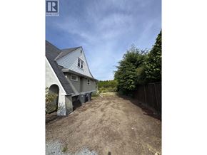 Vancouver apartment for rent - A house with a grey roof and a dirt path leading to it.