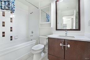 Vancouver apartment for rent - A white toilet sits in a bathroom next to a bathtub.