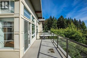 Vancouver apartment for rent - A balcony with glass railings and a glass door leading to a patio.