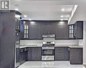 Brampton (Toronto Gore Rural Estate) apartment for rent - A modern kitchen with dark wood cabinets and stainless steel appliances.