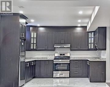 Brampton (Toronto Gore Rural Estate) apartment for rent - A modern kitchen with dark wood cabinets and stainless steel appliances.