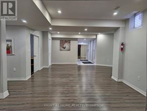Brampton (Toronto Gore Rural Estate) apartment for rent - A spacious room with wooden flooring and white walls.