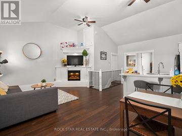 Hamilton (North End) apartment for rent - A living room with a grey couch and a fireplace.