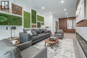 Guelph condo for rent - A living room with a grey couch and a coffee table.