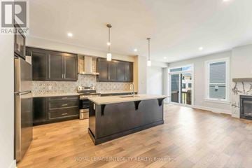Ottawa townhouse for rent - A modern kitchen with dark wood cabinets and a central island.