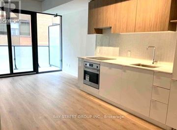 Toronto (Mount Pleasant West) condo for rent - A modern kitchen with a stove top oven and a sink.