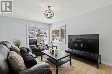 Cambridge apartment for rent - A living room with a black leather couch and a flat screen TV.