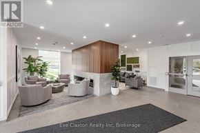 Guelph (Pineridge/Westminster Woods) condo for rent - A modern living room with a fireplace and a large rug.