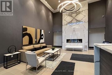 Milton (Walker) condo for rent - A modern living room with a large painting on the wall and a fireplace.