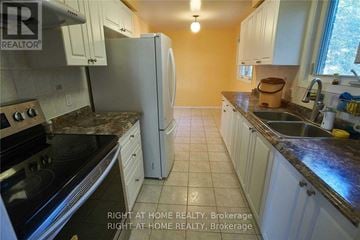 Mississauga (Creditview) apartment for rent - A kitchen with a refrigerator, oven, and sink.