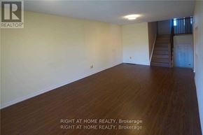 Mississauga (Creditview) apartment for rent - A room with wooden floors and a staircase in the background.