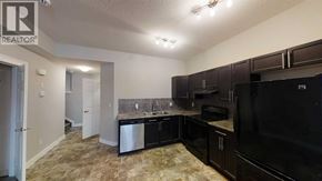 Grande Prairie apartment for rent - A kitchen with black appliances and brown cabinets.