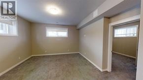 Grande Prairie apartment for rent - A room with a carpeted floor and a window.