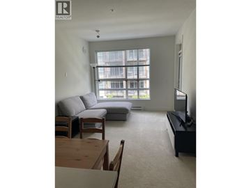 Vancouver apartment for rent - A living room with a grey couch and a wooden coffee table.
