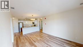Grande Prairie apartment for rent - A large empty room with wooden floors and white walls.