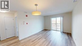 Grande Prairie apartment for rent - A room with a wooden floor and a sliding glass door leading to a balcony.