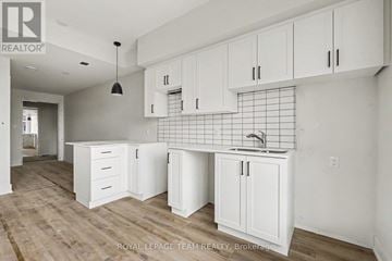 North Grenville multi-family for rent - A kitchen with white cabinets and a sink.