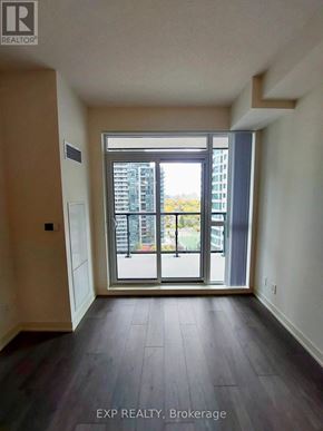 Toronto (Willowdale East) condo for rent - A room with a view of a building through a glass door.