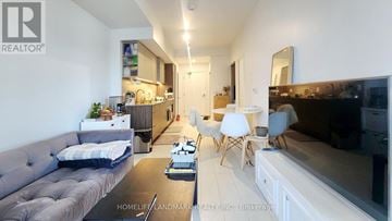 Toronto (Niagara) condo for rent - A living room with a grey couch and a black coffee table.