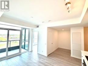 Toronto (Clairlea-Birchmount) condo for rent - A spacious room with a sliding glass door leading to a balcony.