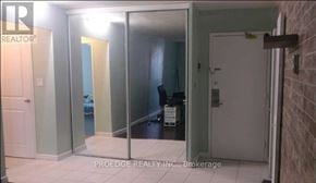 Toronto (Crescent Town) condo for rent - A room with a glass door and a white door.