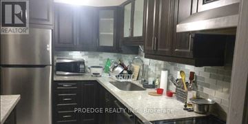 Toronto (Crescent Town) condo for rent - A kitchen with a refrigerator and a sink.