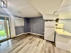 Pickering (Brock Ridge) apartment for rent - A spacious room with a slanted ceiling and a kitchenette.