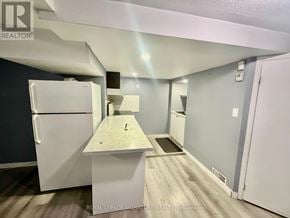 Pickering (Brock Ridge) apartment for rent - A kitchen with a white fridge and a counter top.