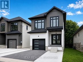 Guelph (Exhibition Park) duplex for rent - A modern house with a black garage door is for sale.