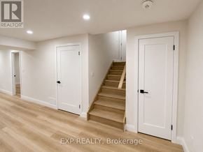 Guelph (Exhibition Park) duplex for rent - A white door is in a room with wooden floors.