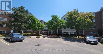 Ottawa condo for rent - A parking lot with cars and a sign that says "Right at Home Realty, Brokerage".