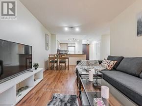 Toronto (Waterfront Communities) condo for rent - A modern living room with a grey sofa and wooden floors.