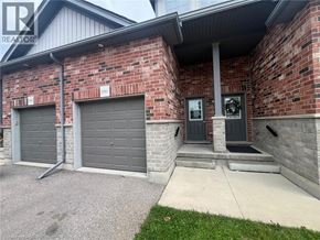 Kitchener townhouse for rent - A house with a grey garage door and a black door.