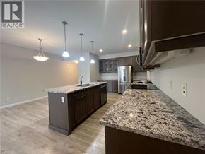 Kitchener townhouse for rent - A kitchen with granite countertops and wooden floors.