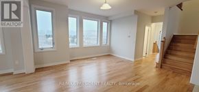 Woodstock (Woodstock - North) apartment for rent - A large, empty room with wooden floors and a staircase on the right.