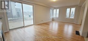 Woodstock (Woodstock - North) apartment for rent - A large empty room with wooden floors and sliding glass doors.