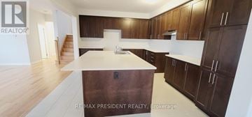 Woodstock (Woodstock - North) apartment for rent - A kitchen with brown cabinets and a white countertop.