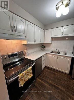 Welland (Prince Charles) condo for rent - A kitchen with white cabinets and a black stove top oven.