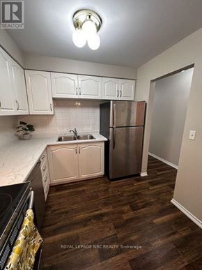 Welland (Prince Charles) condo for rent - A kitchen with white cabinets and a stainless steel refrigerator.