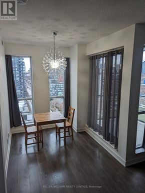 Toronto (Regent Park) condo for rent - A dining room with a wooden table and chairs.