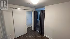 Toronto (Regent Park) condo for rent - A room with a white door and grey curtains.