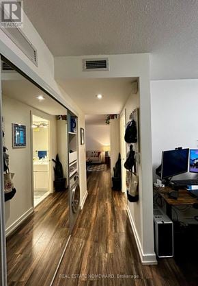 Toronto (Waterfront Communities) condo for rent - A hallway with wood floors and a white ceiling.